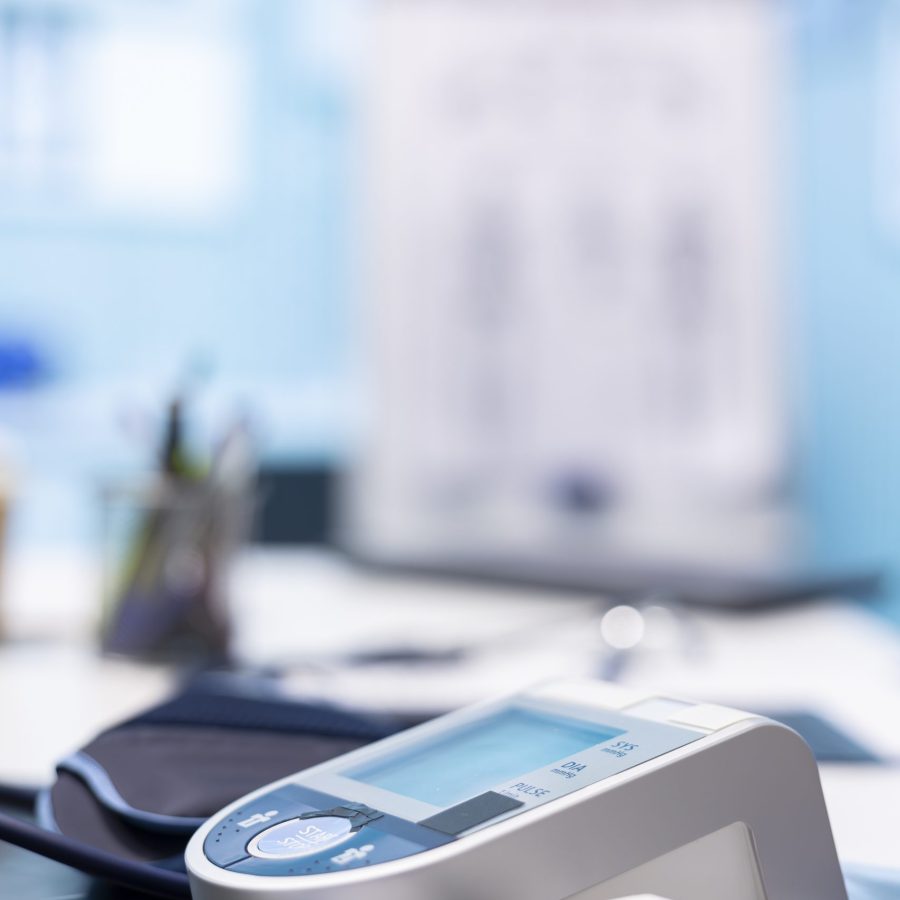 Empty medical office equipped with diagnostic tools and blood pressure monitor set for healthcare consultations and medical research to provide accurate diagnosis and patient care. Close up.